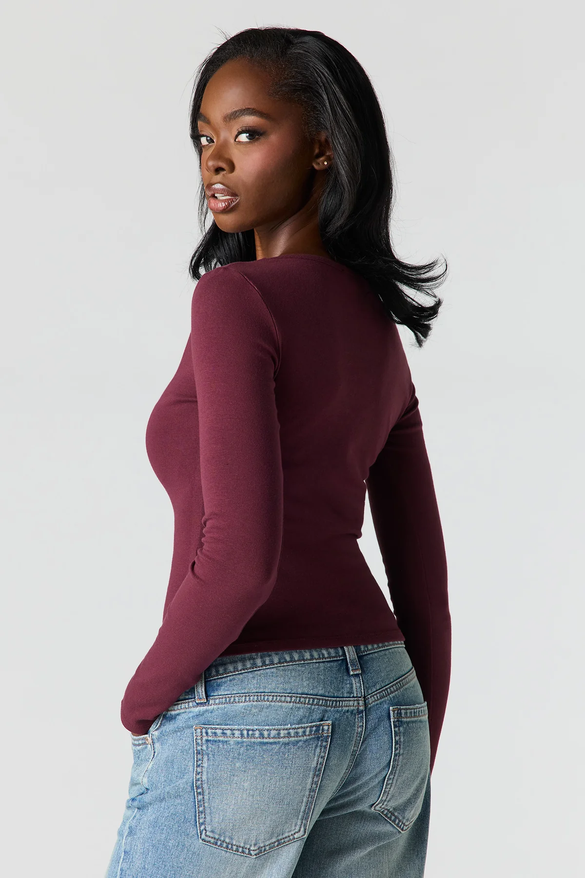 Velmora burgundy fitted stretch knit top with deep V neck and long sleeves