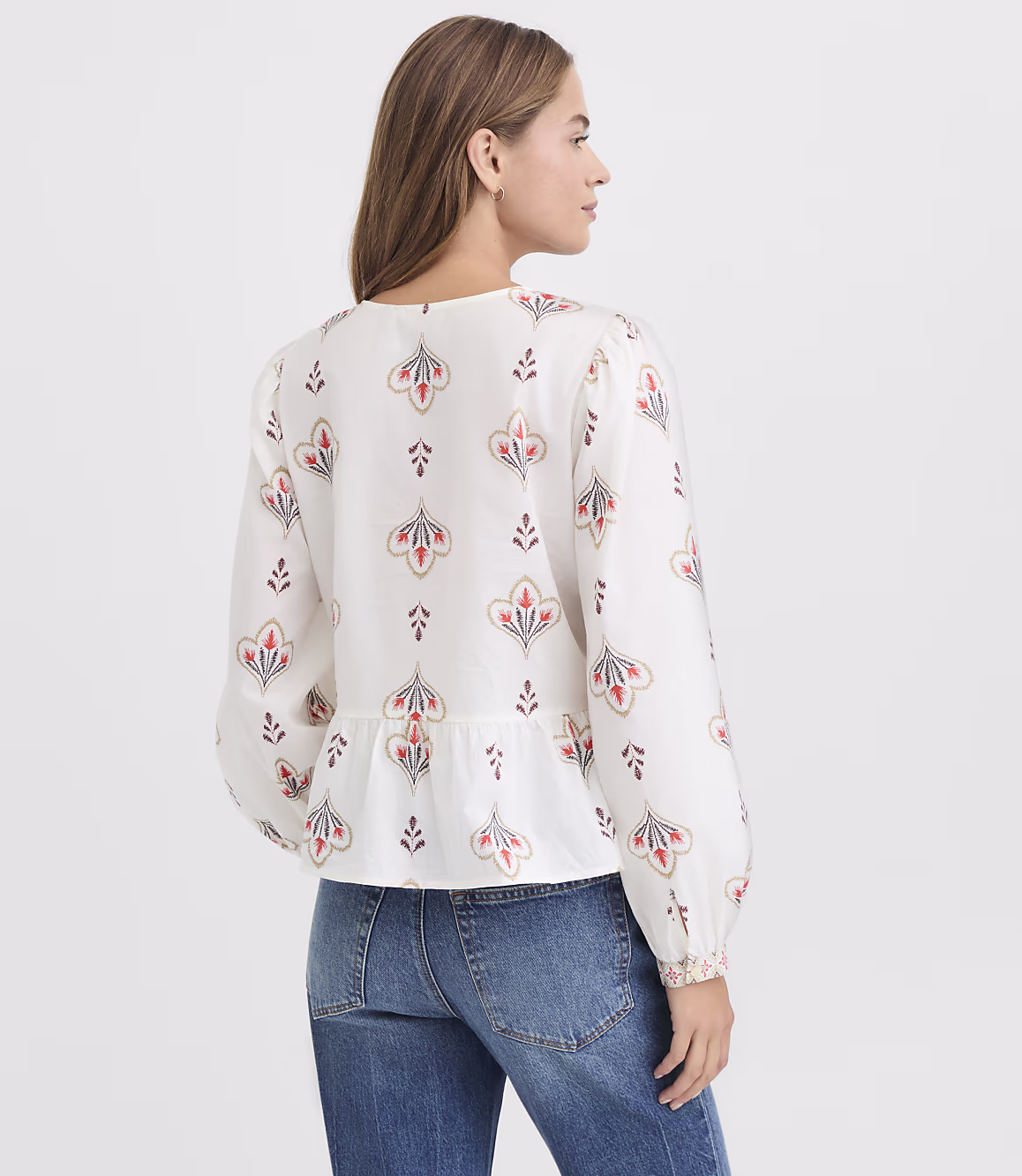 Close view of the ivory floral print on the Zarevia peplum top