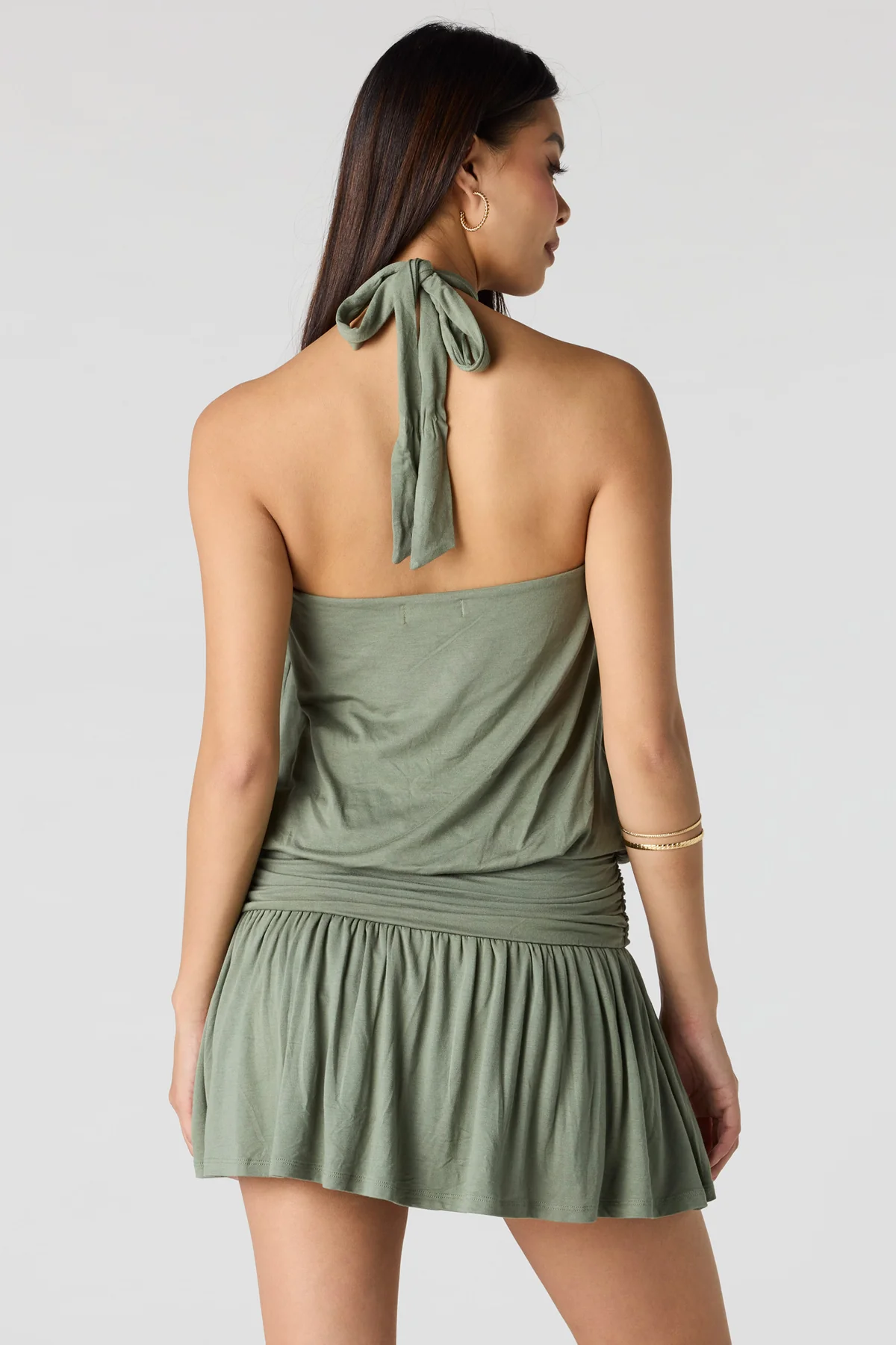 Sage green halter neck mini dress with drop waist and flowy skirt